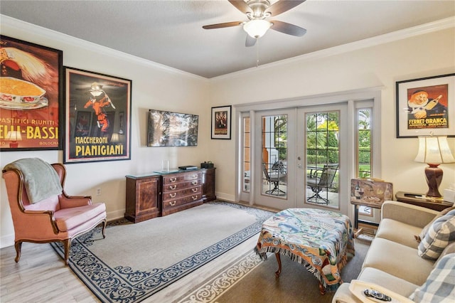 living area with ceiling fan, light hardwood / wood-style floors, ornamental molding, and french doors