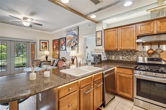 kitchen with backsplash, stainless steel appliances, sink, light tile patterned floors, and ceiling fan