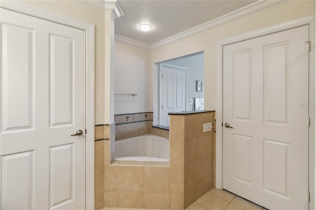 bathroom with tiled tub, a textured ceiling, tile patterned floors, and ornamental molding