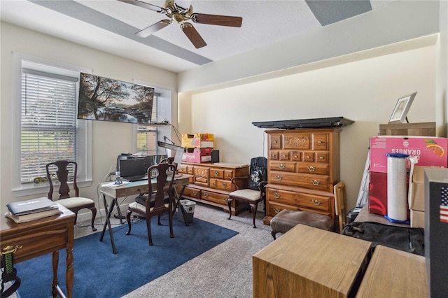 carpeted home office with ceiling fan