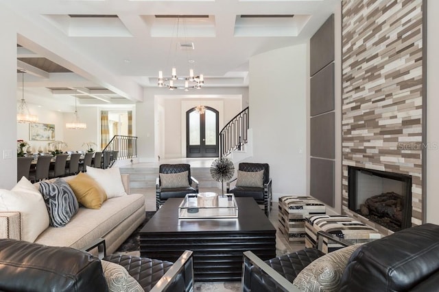 interior space with beam ceiling, coffered ceiling, a fireplace, a notable chandelier, and a towering ceiling