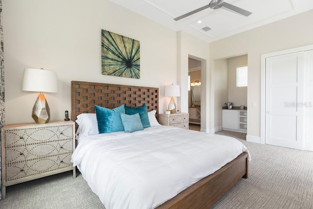 carpeted bedroom featuring ceiling fan and ensuite bathroom