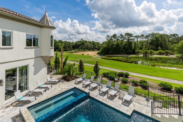 view of pool with a patio and a yard