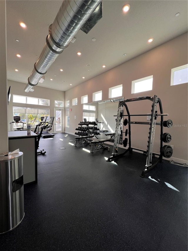 gym featuring baseboards and recessed lighting