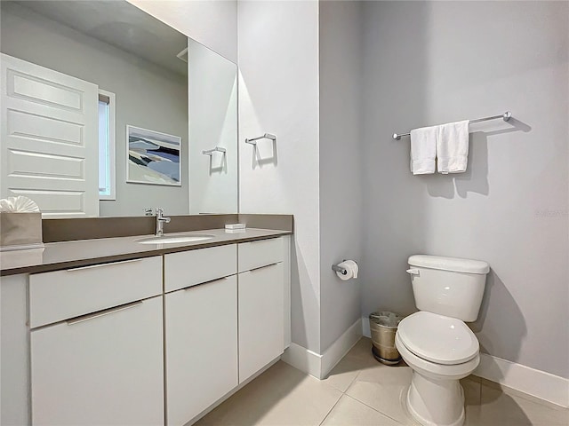 bathroom featuring vanity, toilet, and tile patterned floors