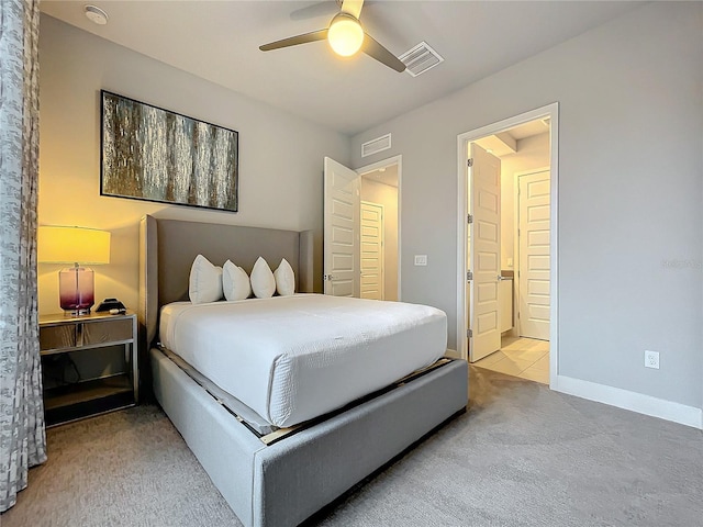 bedroom featuring a ceiling fan, visible vents, light carpet, and baseboards