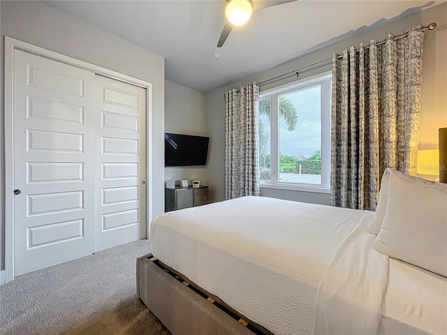 carpeted bedroom featuring a ceiling fan and a closet