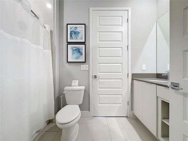 bathroom with vanity, toilet, tile patterned floors, and walk in shower