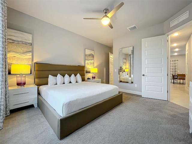 carpeted bedroom with visible vents and ceiling fan