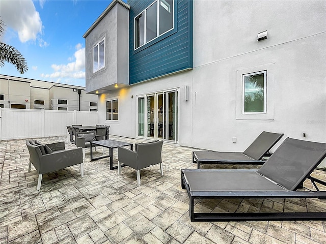 view of patio / terrace with fence and an outdoor living space