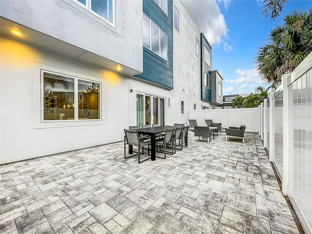 view of patio featuring outdoor dining area, outdoor lounge area, and a fenced backyard