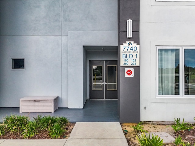 doorway to property with stucco siding