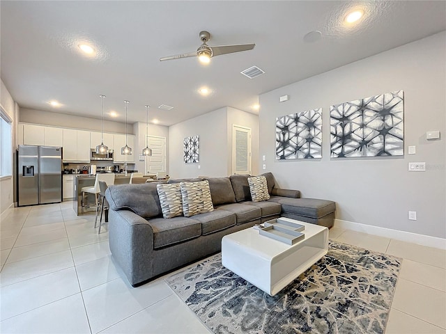 living room with ceiling fan and light tile patterned flooring