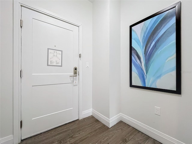 entryway featuring dark wood-style flooring and baseboards