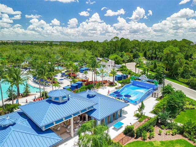 birds eye view of property featuring a view of trees