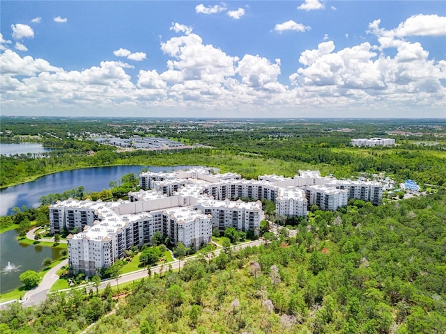 aerial view with a water view and a wooded view