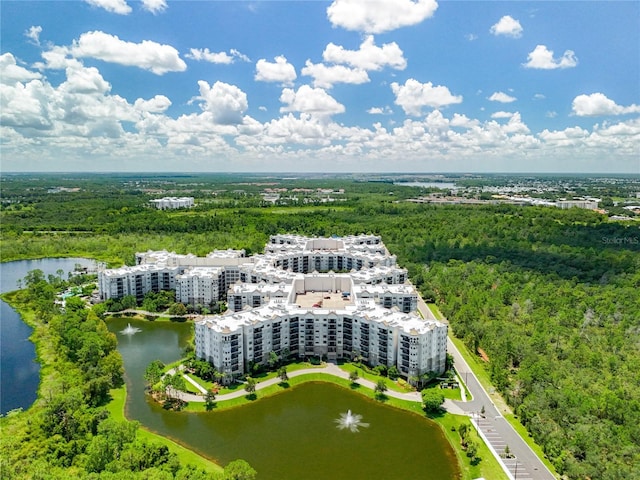 aerial view with a water view and a wooded view