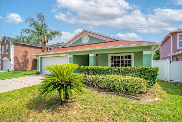 view of front of property with a front yard and a garage