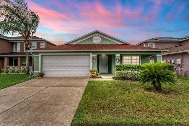 view of front of property with a lawn and a garage