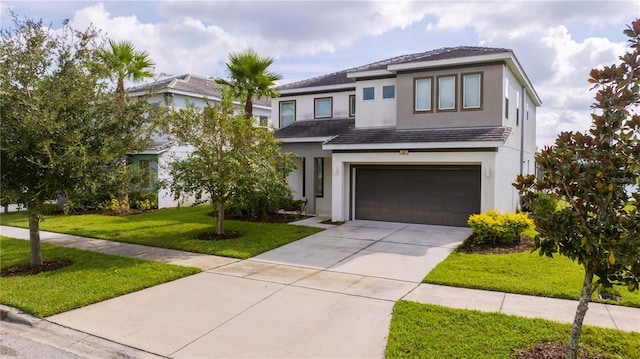 view of front of house featuring a front lawn and a garage