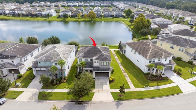 bird's eye view featuring a water view and a residential view