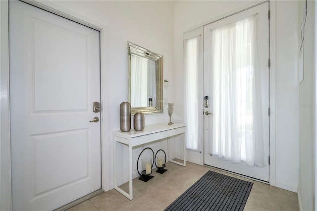 entryway with light tile patterned flooring and a healthy amount of sunlight