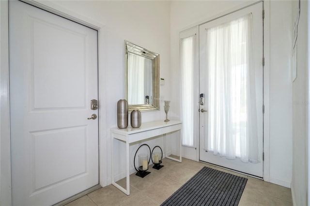 doorway to outside featuring light tile patterned floors