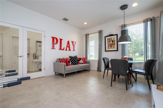 dining area featuring light tile patterned flooring, a wealth of natural light, and french doors