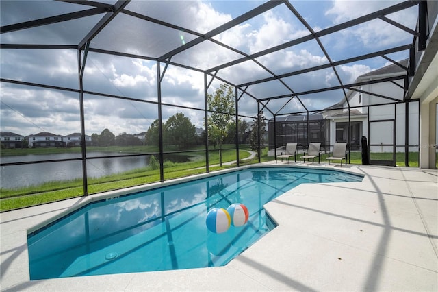 view of pool with glass enclosure and a patio area