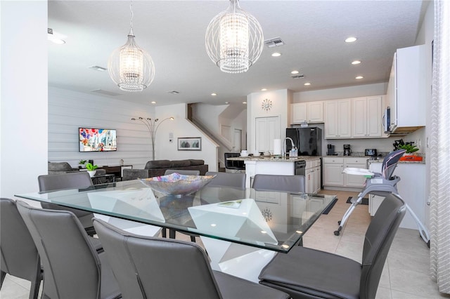 dining space with a chandelier and light tile patterned floors