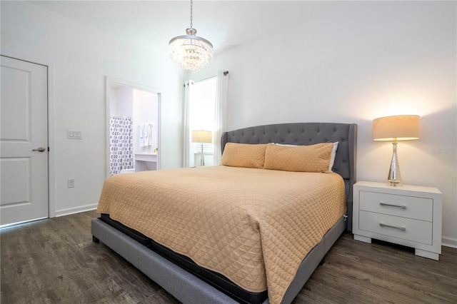 bedroom featuring a notable chandelier and dark wood-type flooring