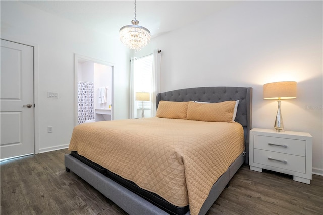 bedroom with dark wood-style floors, baseboards, and a notable chandelier