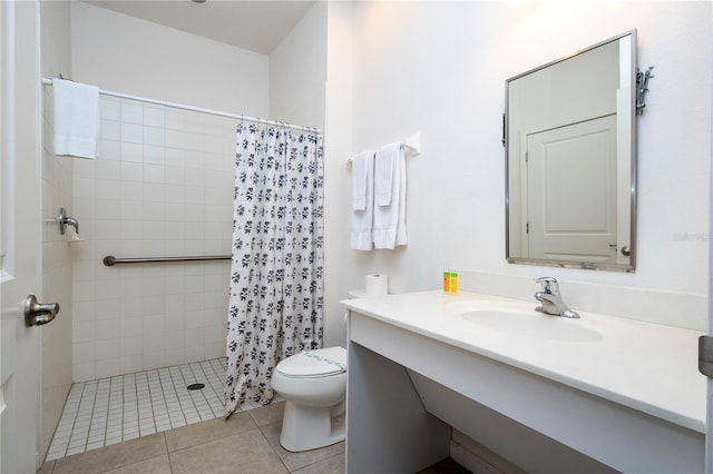 bathroom featuring curtained shower, toilet, tile patterned floors, and vanity