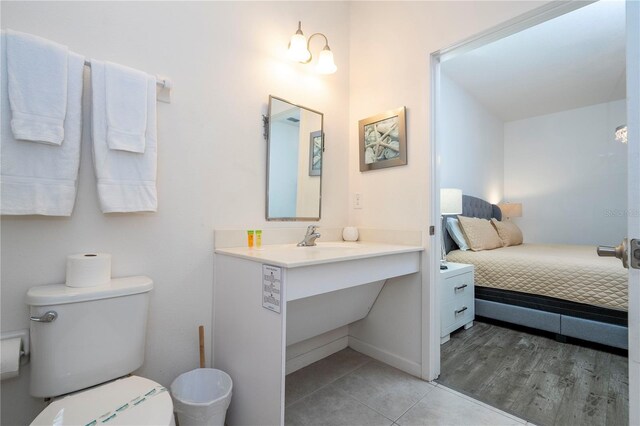 bathroom with vanity, hardwood / wood-style floors, and toilet