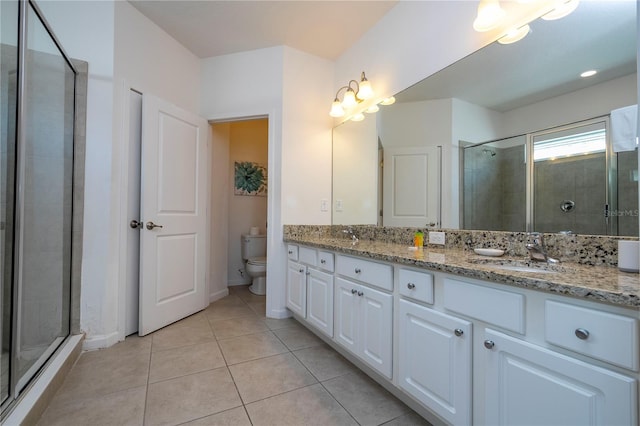 bathroom with tile patterned flooring, walk in shower, dual vanity, and toilet