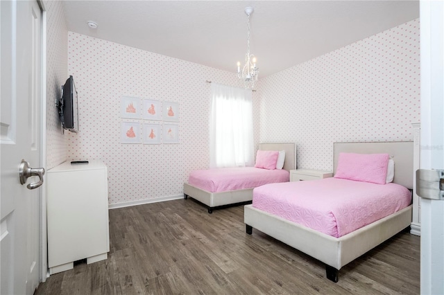 bedroom featuring hardwood / wood-style floors and a notable chandelier