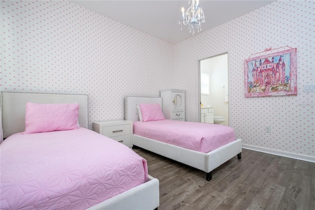 bedroom with hardwood / wood-style floors, connected bathroom, and a notable chandelier