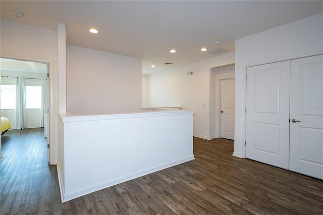 unfurnished room featuring baseboards, dark wood-style flooring, visible vents, and recessed lighting