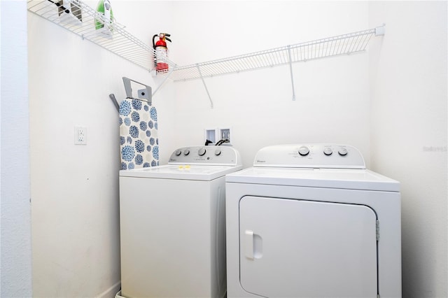 clothes washing area featuring washing machine and dryer and laundry area