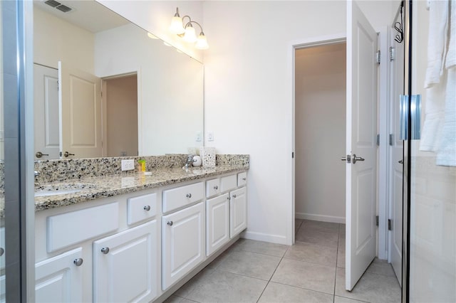 bathroom with double vanity and tile patterned floors