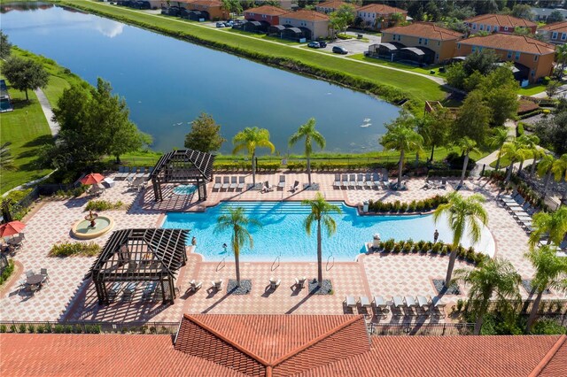 view of swimming pool featuring a patio area and a water view