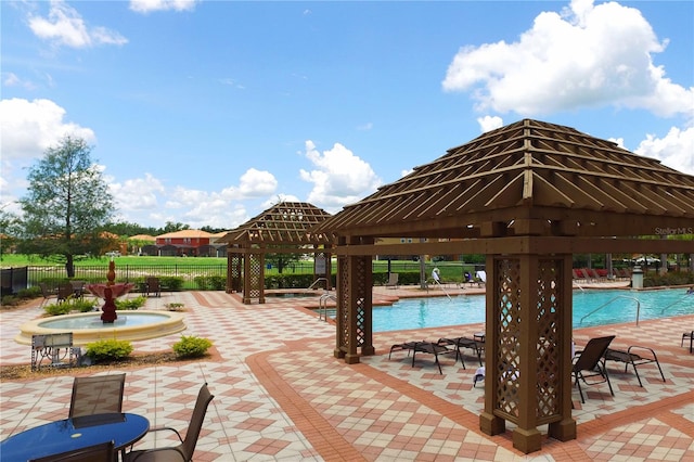 view of patio with a gazebo and a community pool