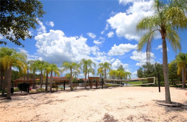 view of community with fence and volleyball court