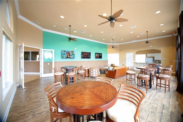 dining space featuring ceiling fan, wood-type flooring, and ornamental molding