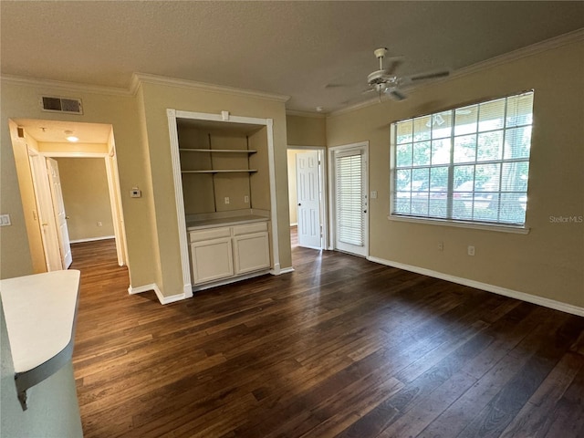 unfurnished bedroom with ceiling fan, dark hardwood / wood-style floors, and ornamental molding