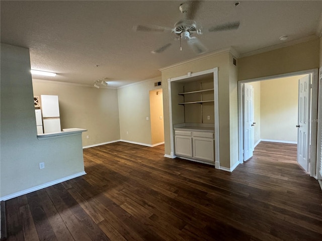 interior space featuring ceiling fan, a textured ceiling, crown molding, and dark wood-type flooring