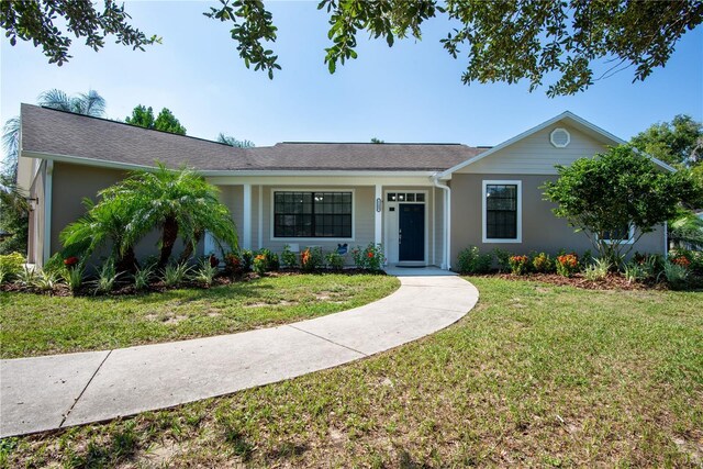 ranch-style home with a front lawn