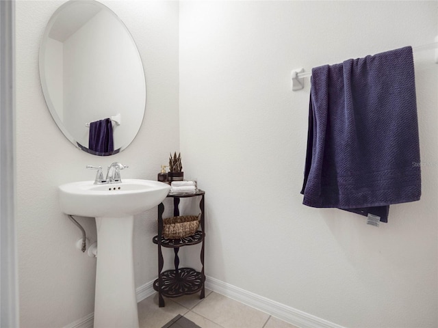 bathroom with baseboards and tile patterned floors