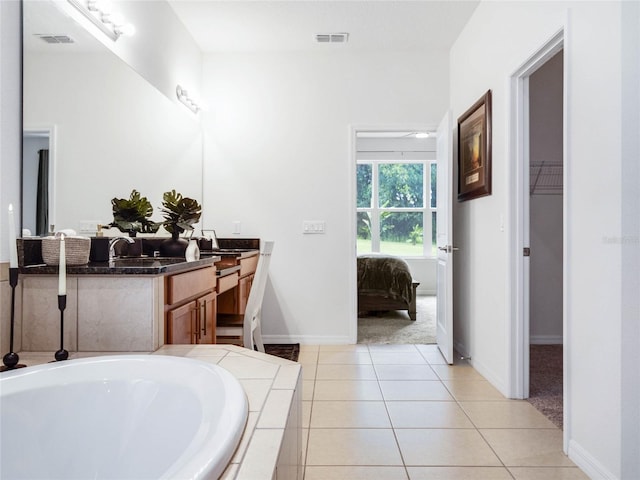 ensuite bathroom featuring visible vents, vanity, ensuite bath, tile patterned flooring, and a bath