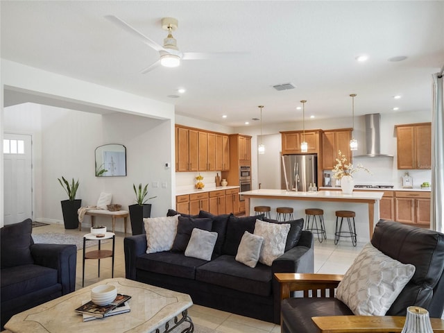 tiled living room featuring ceiling fan